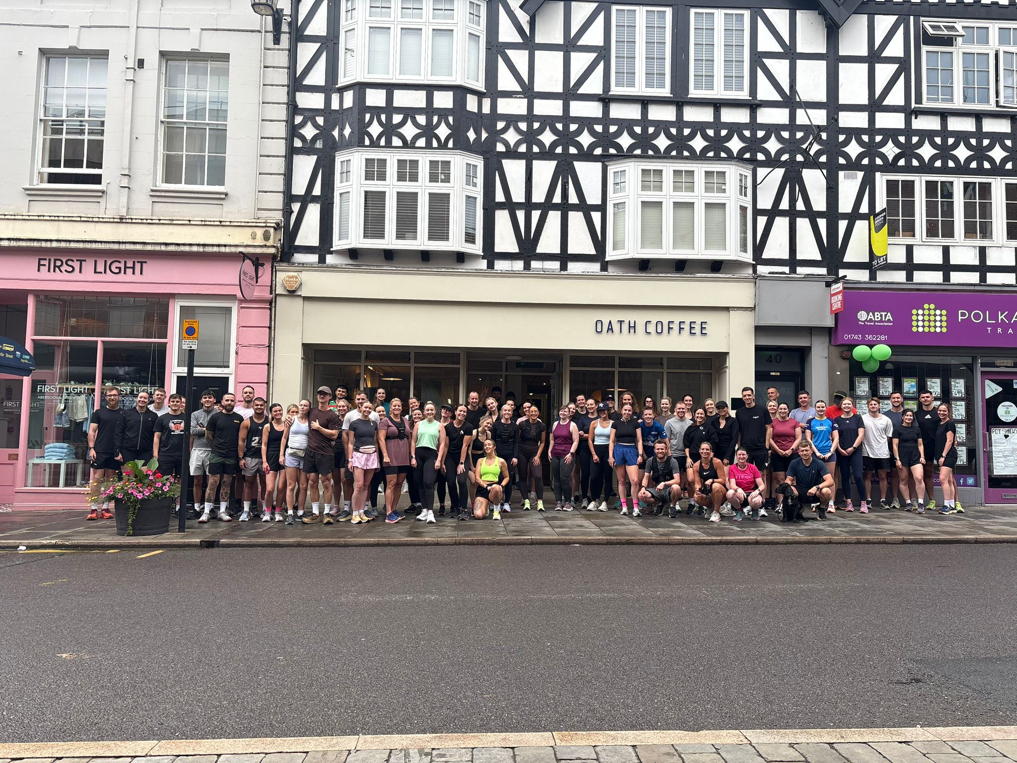 A community run club gathered outside a high-street café